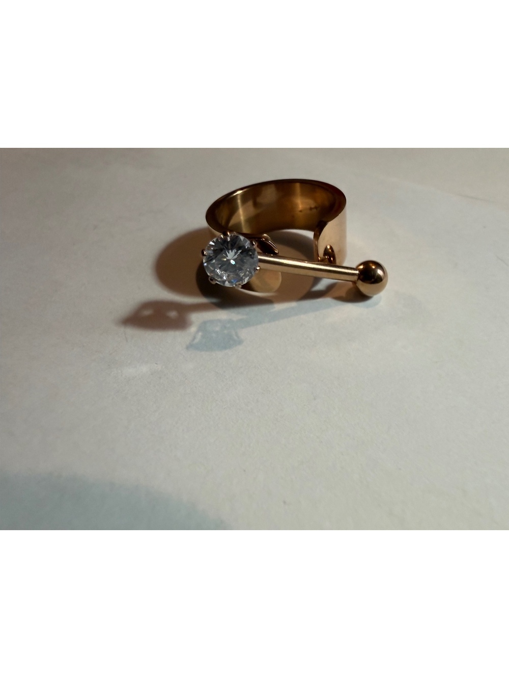 Gold tone open ring with clear stone
